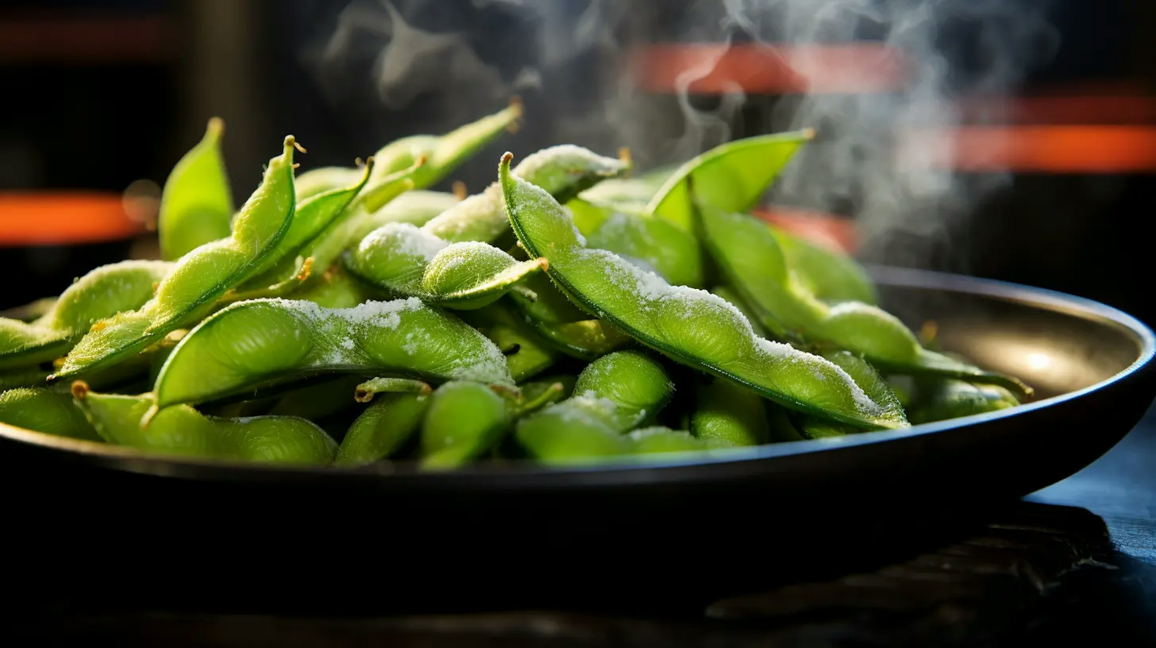 Steamed edamame pods on a ceramic plate